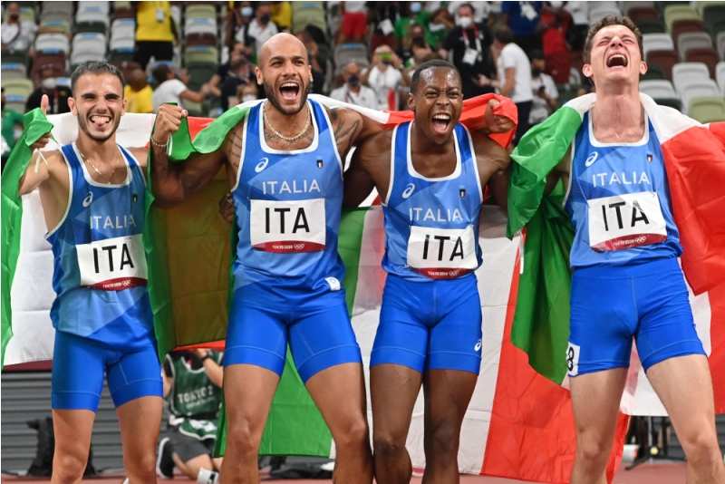 Lamont Marcell Jacobs celebrating his victory with other members of the Italian team in the 4×100 m relay event at the 2020 Tokyo Olympics