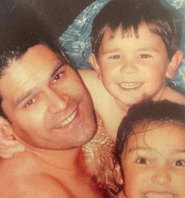 A childhood picture of KJ Apa (in middle) with his father and sister