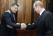 Vladimir Putin shakes hand with the member of Lyube
