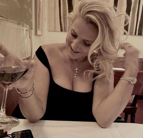Natacha Nikolajevic drinking a glass of red wine 