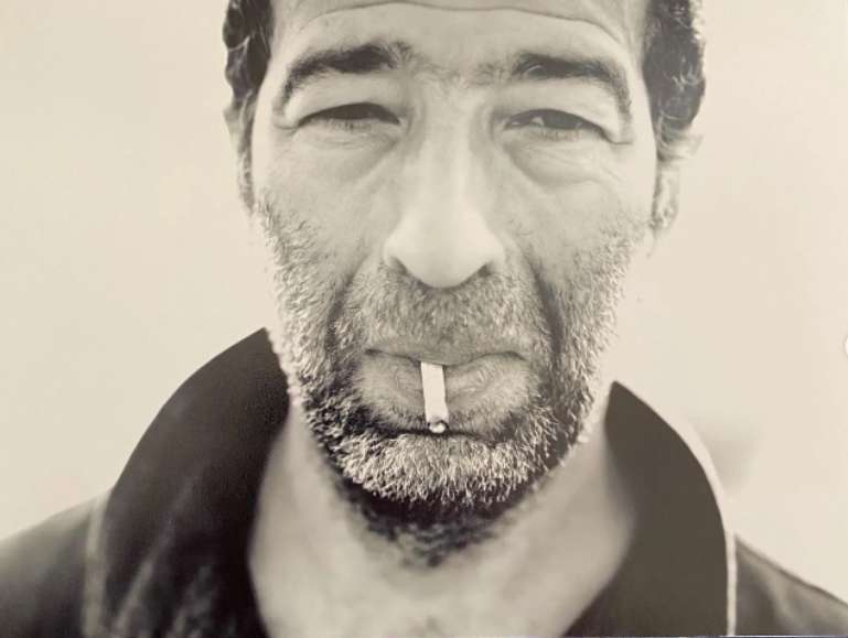 A photo of Slimane Dazi smoking